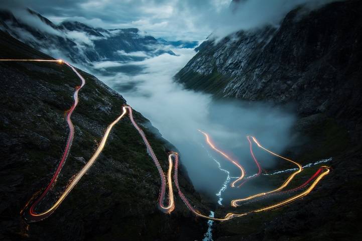 I took this photo in july 2014 at Trollstigen in Norway. Standing there alone in the fog, I was waiting for the view to become clear. And then it happened, the fog disappeared and though it was 1 am already, one car came slowly up the steep serpentines. It was my dream for a long time to take a photo of lighttrails like this in Norway - and it was just an awesome feeling that it worked out on the most beautiful and famous street. A few minutes later the fog returned, even thicker than before.